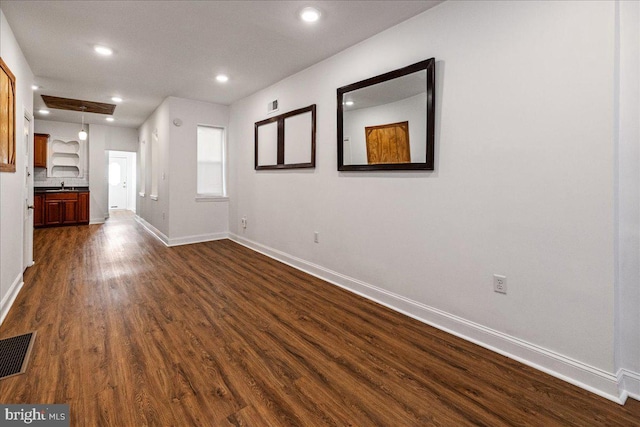 interior space with dark hardwood / wood-style flooring and sink