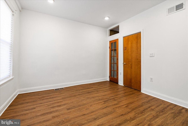 unfurnished room featuring dark hardwood / wood-style floors