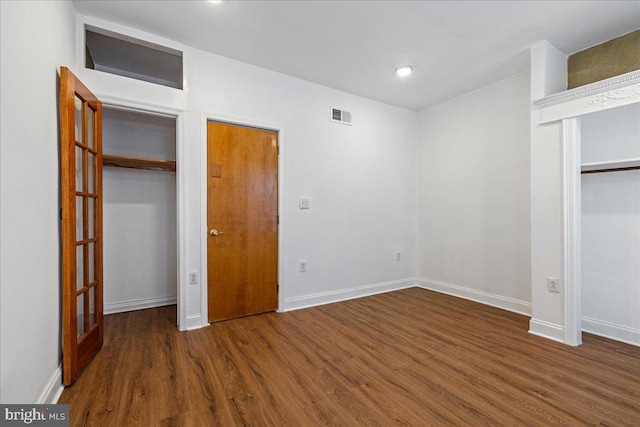 unfurnished bedroom featuring dark hardwood / wood-style floors