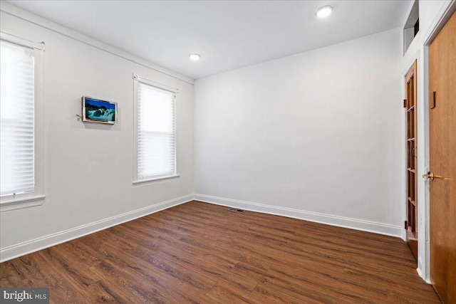 unfurnished room with dark hardwood / wood-style floors