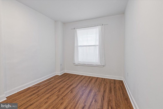 empty room with dark wood-type flooring