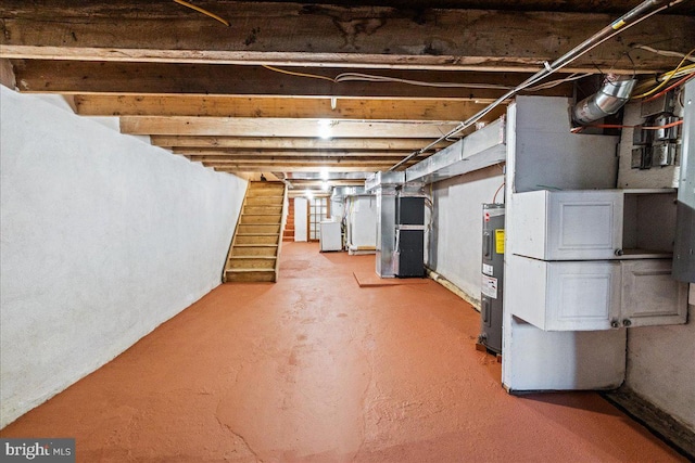 basement featuring heating unit and water heater