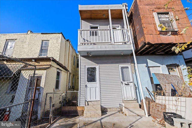 back of property with a balcony