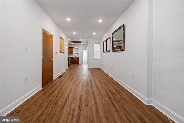 unfurnished living room with dark wood-type flooring