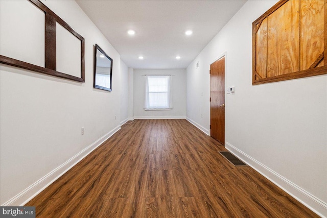 spare room with dark wood-type flooring