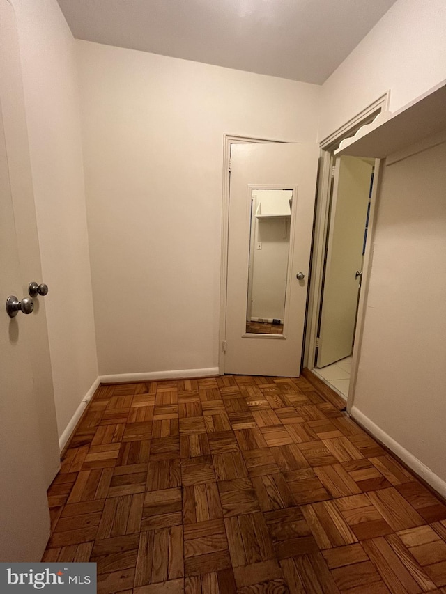 corridor featuring dark parquet flooring