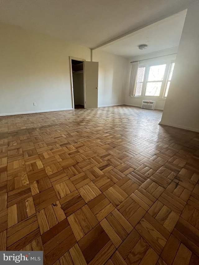 empty room featuring parquet flooring and a wall unit AC