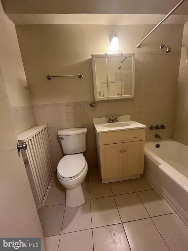 full bathroom featuring tile patterned flooring, vanity, toilet, and tile walls