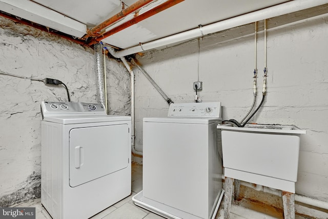 laundry area featuring separate washer and dryer and sink