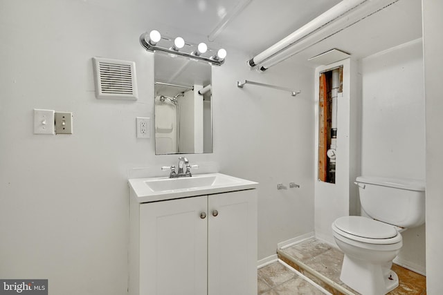 bathroom featuring tile patterned floors, vanity, and toilet