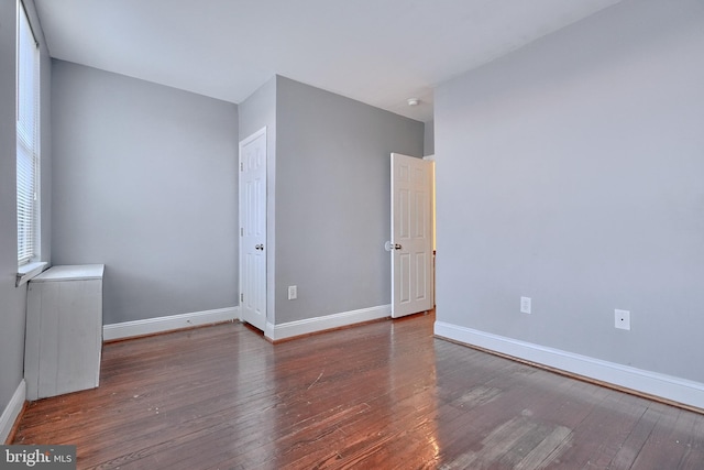 spare room with dark hardwood / wood-style floors