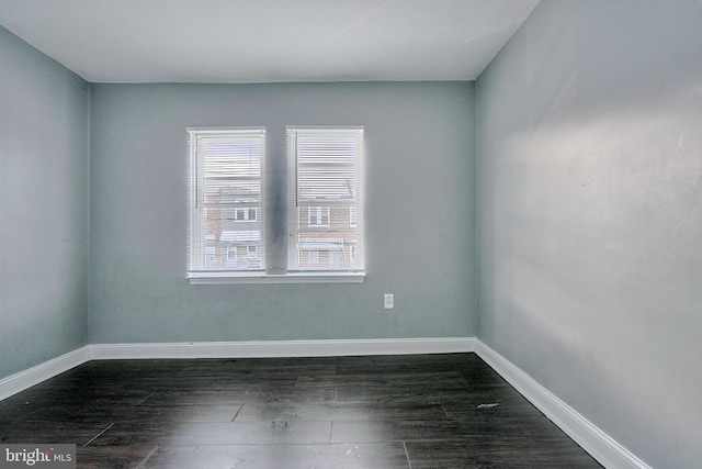 empty room featuring dark hardwood / wood-style flooring