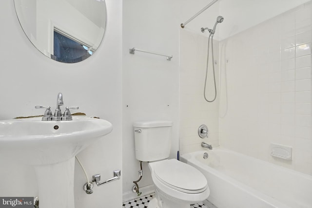 full bathroom with sink, tile patterned flooring, toilet, and tiled shower / bath