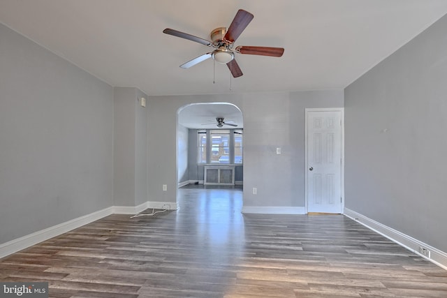 empty room featuring ceiling fan and hardwood / wood-style floors