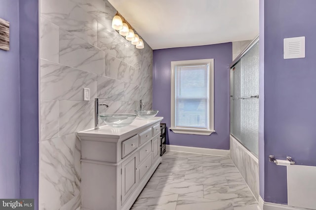 bathroom with vanity and a shower with shower door