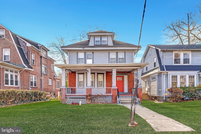 view of front of home with covered porch and a front yard