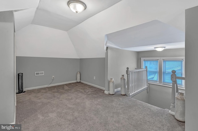 additional living space with light colored carpet and lofted ceiling