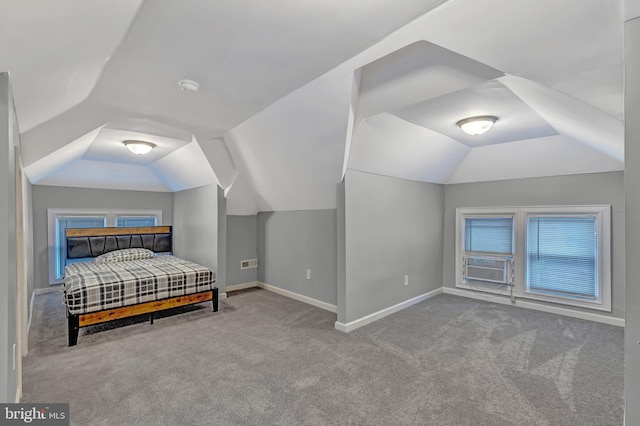 carpeted bedroom with cooling unit and vaulted ceiling