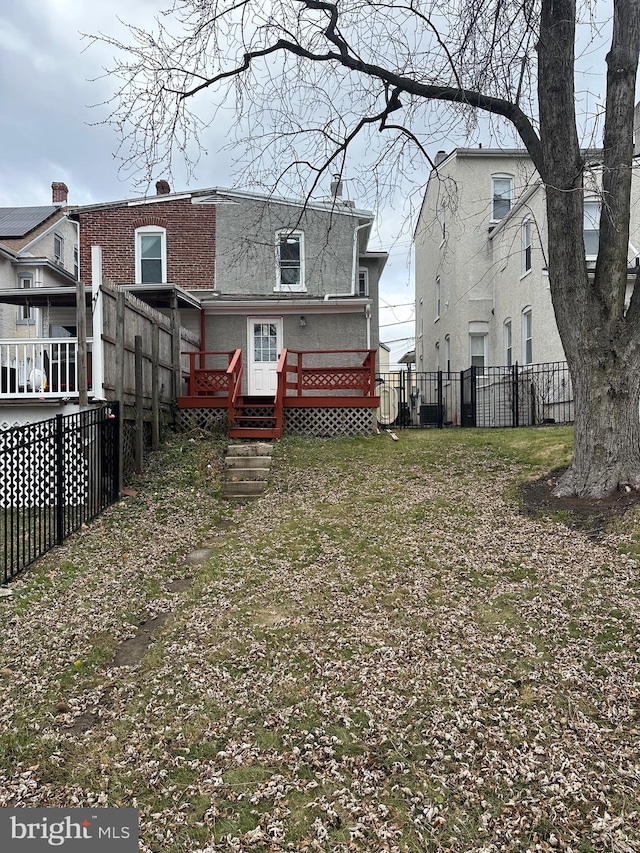 rear view of house with a wooden deck