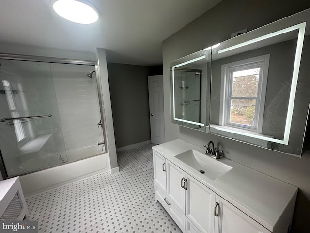 bathroom featuring vanity and combined bath / shower with glass door