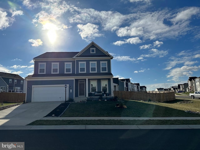 view of front of property with a front yard and a garage