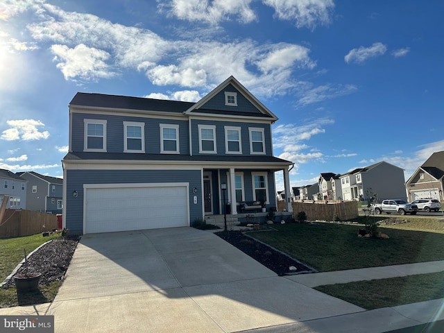 view of front of property featuring a front lawn, covered porch, and a garage