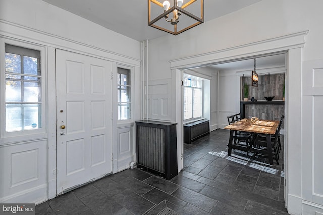 foyer entrance with an inviting chandelier