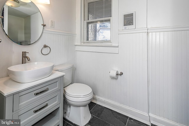 bathroom with tile patterned flooring, vanity, and toilet