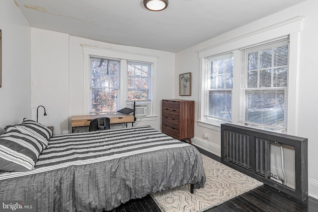 bedroom with dark hardwood / wood-style flooring and cooling unit