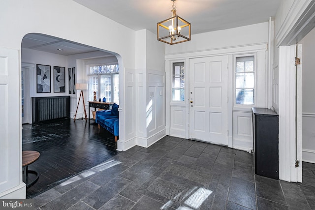 entrance foyer featuring a wealth of natural light and a notable chandelier