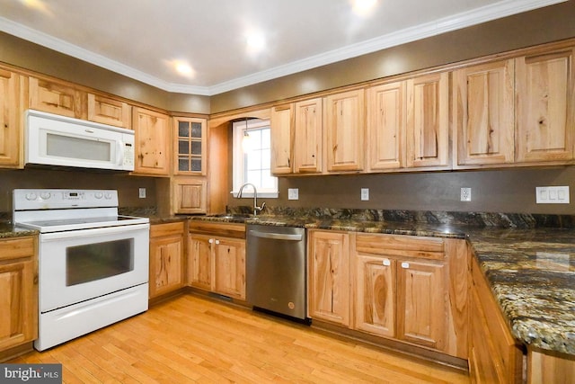 kitchen with light hardwood / wood-style flooring, sink, dark stone counters, white appliances, and ornamental molding