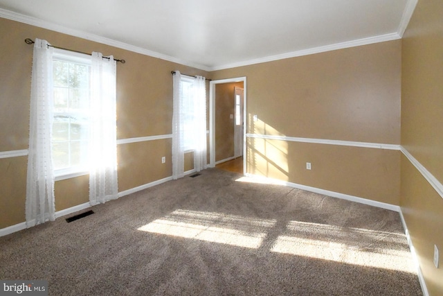 carpeted spare room featuring crown molding