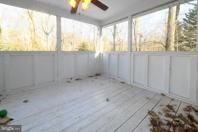 unfurnished sunroom featuring ceiling fan