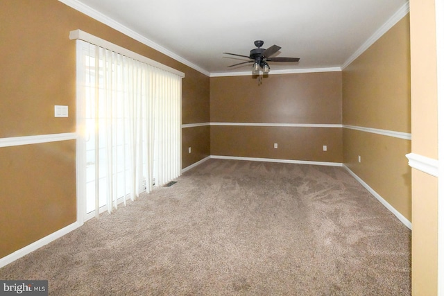 carpeted spare room with ceiling fan and crown molding