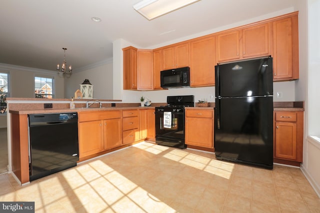 kitchen with black appliances, sink, hanging light fixtures, ornamental molding, and a chandelier