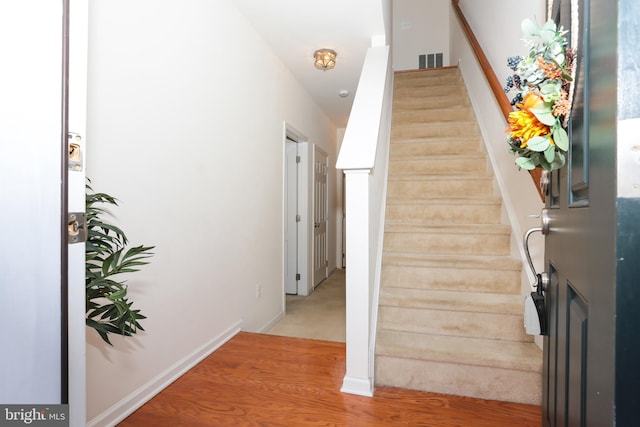 stairway featuring hardwood / wood-style flooring