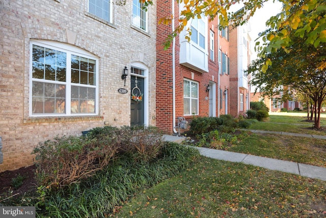 entrance to property with a lawn