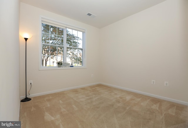 unfurnished room featuring light colored carpet