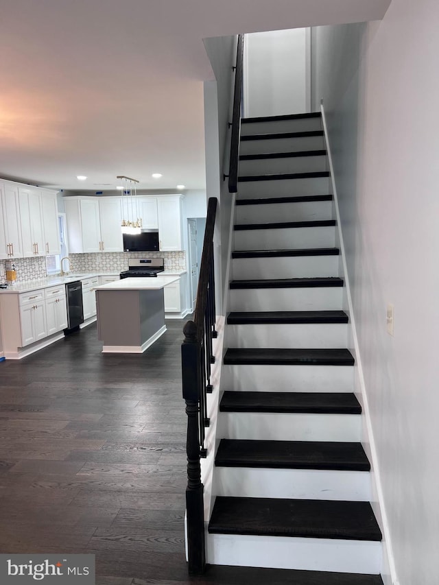 stairway with hardwood / wood-style floors