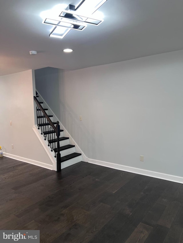 basement with dark hardwood / wood-style flooring