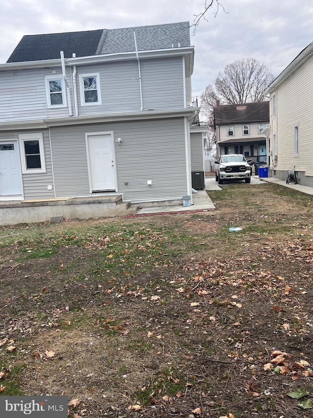 rear view of property with central air condition unit