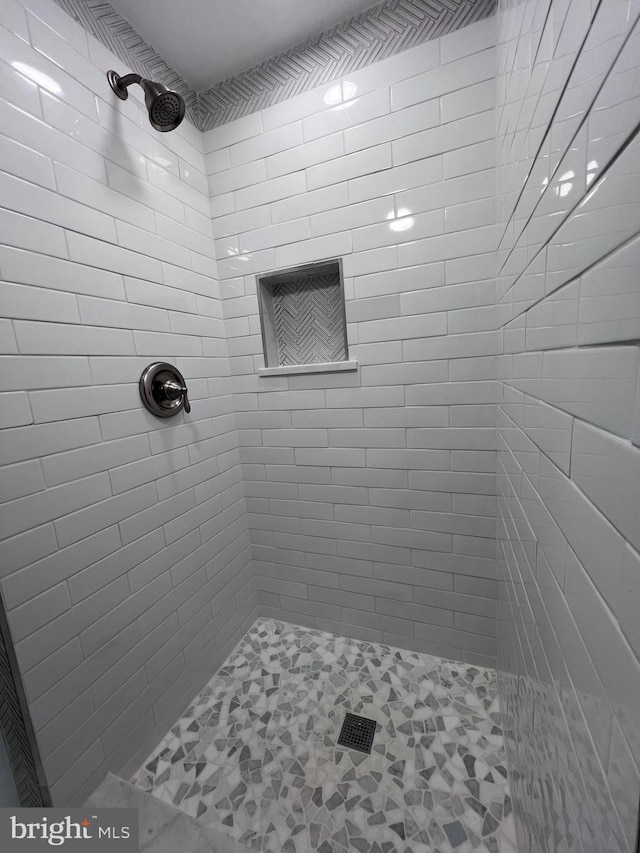 bathroom with a tile shower