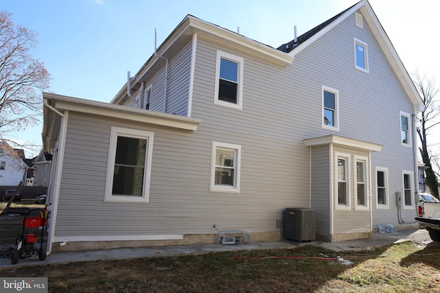 back of house with central air condition unit