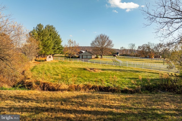 view of yard with a rural view