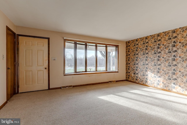 spare room with light colored carpet