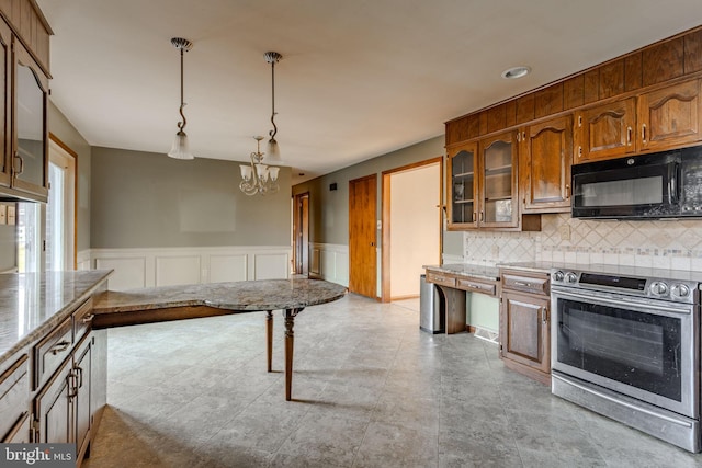 kitchen featuring stainless steel electric range, light stone countertops, tasteful backsplash, decorative light fixtures, and a chandelier