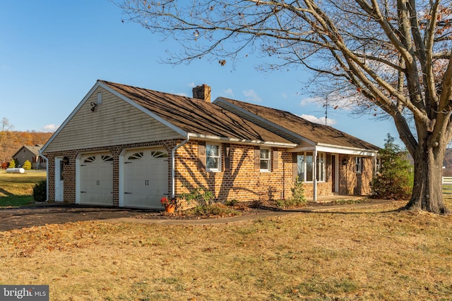 ranch-style home featuring a garage and a front yard