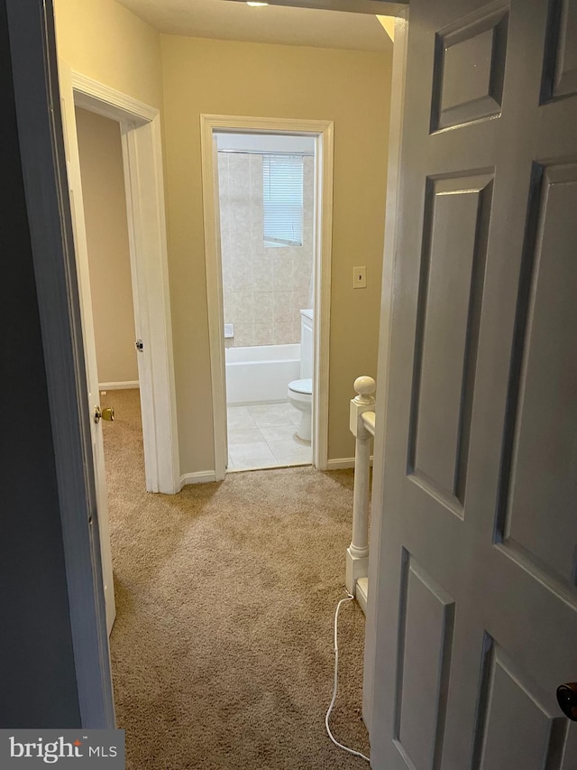 hallway with light colored carpet