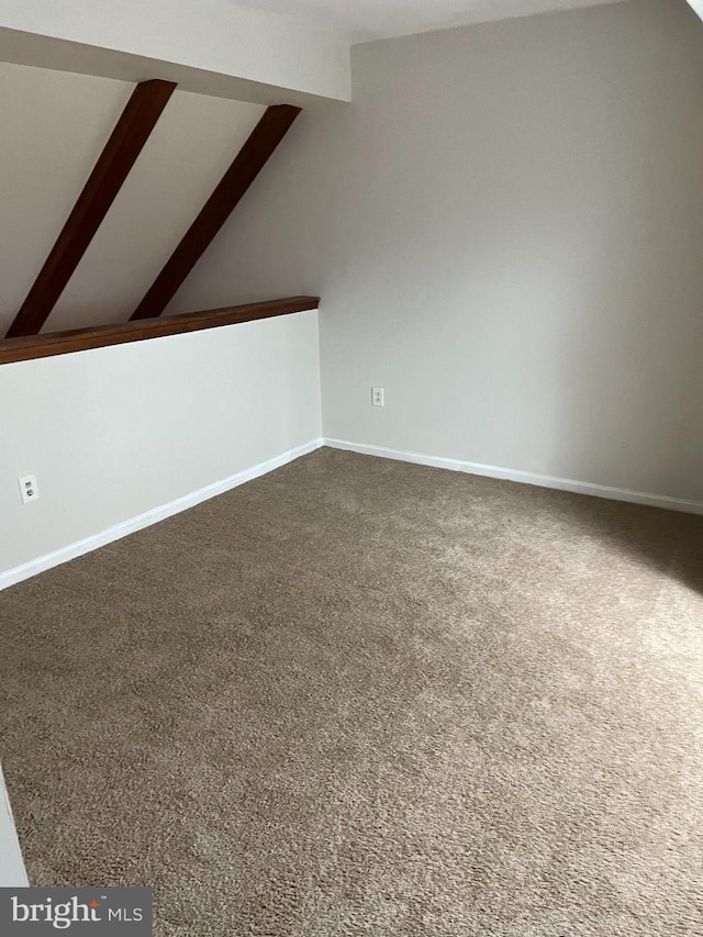 bonus room featuring carpet and vaulted ceiling with beams