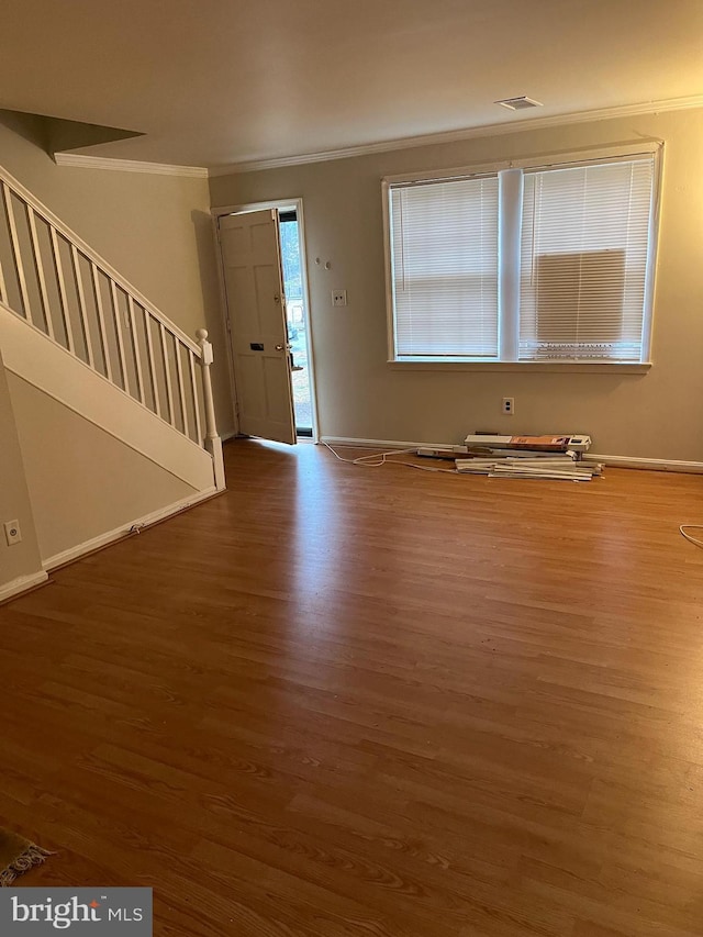 foyer featuring crown molding and hardwood / wood-style floors